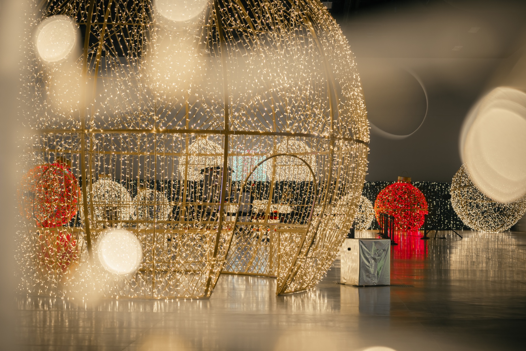 Giant illuminated gold ornament installations at Holiday Wonder