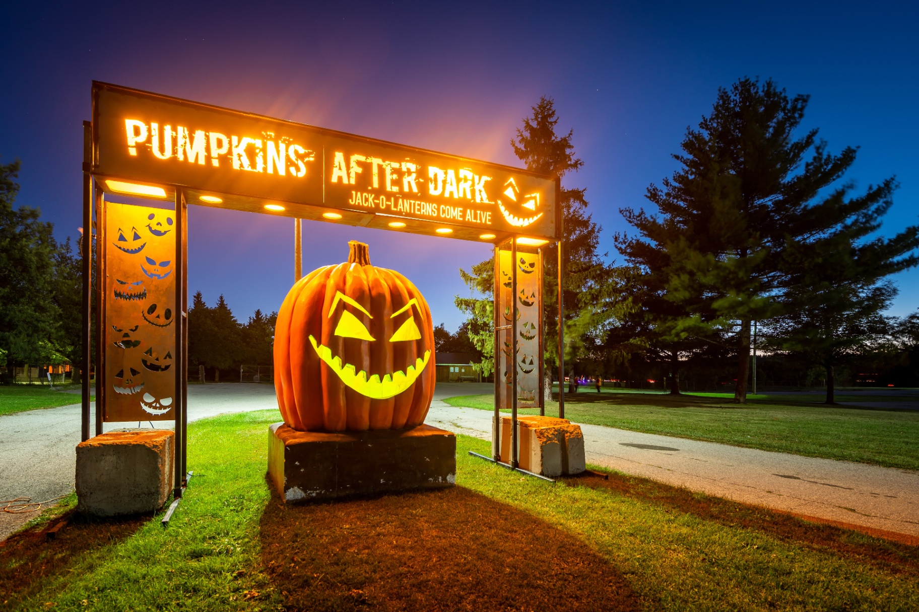 Pumpkins After Dark entry archway lit at dusk